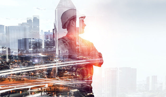 Construction worker overlaid on cityscape background, showcasing modern civil engineering with BIM software in use.