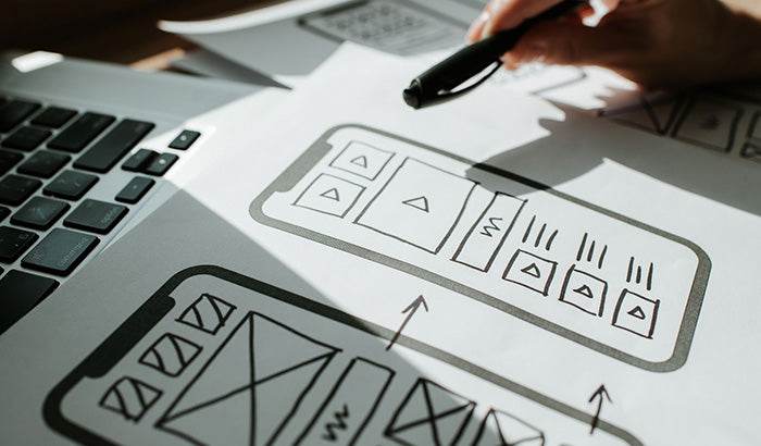 A Person Designing a Mobile App With Prosoft and Apps Logos in the Background