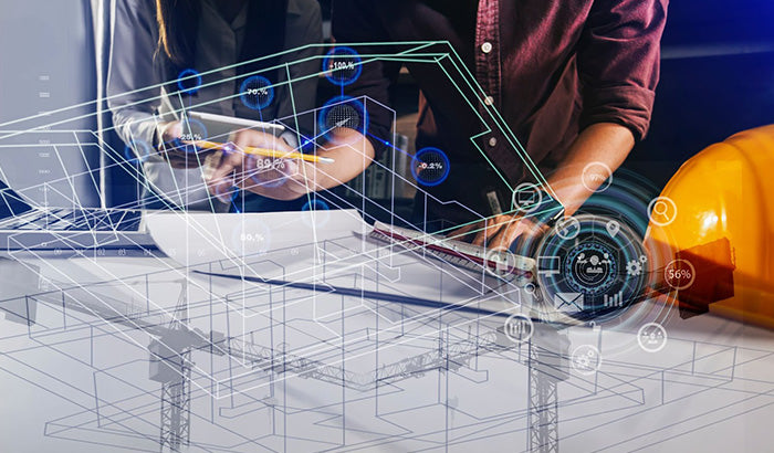 Woman in hardhat working on blueprint with Autodesk software